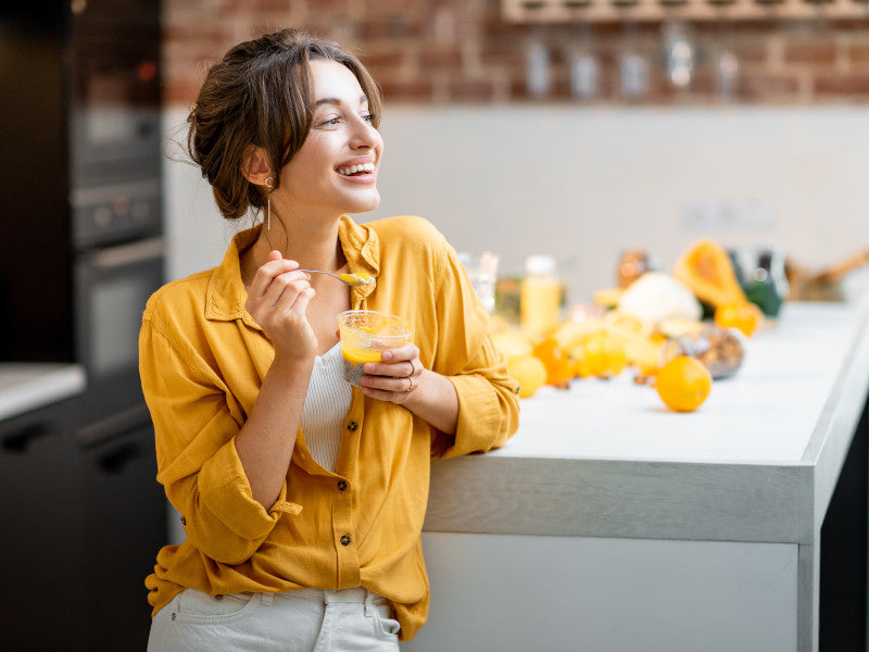 woman smiling while eating